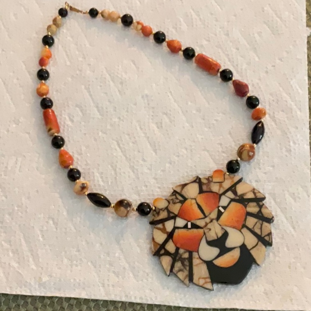 Unique lion necklace with inlaid stone and beaded necklace.